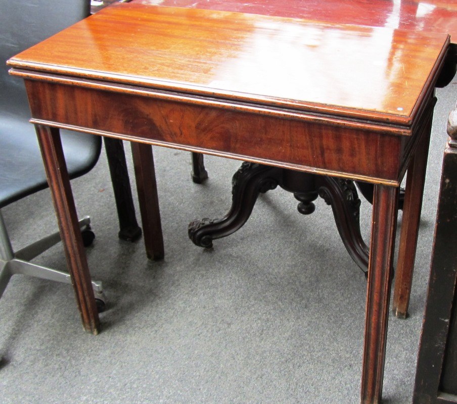 Appraisal: An th century mahogany tea table with fold-out rectangular top