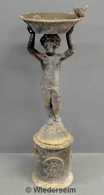 Appraisal: Two-part lead garden fountain of a boy holding a round