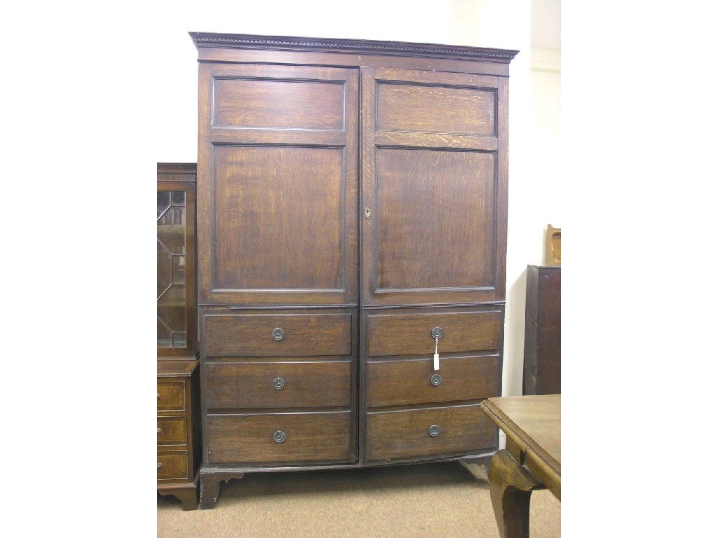 Appraisal: A late th century oak linen cupboard pair of full-length