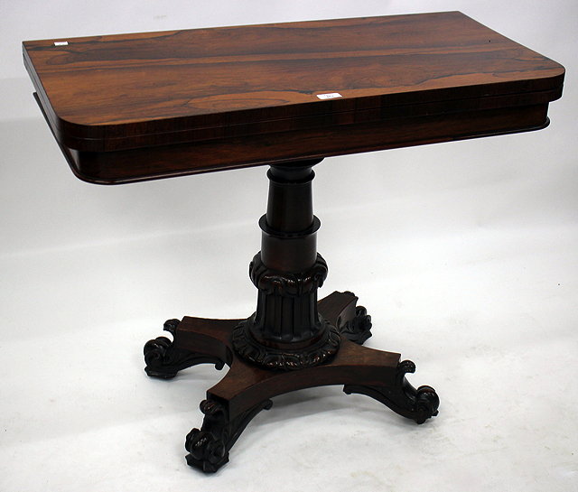 Appraisal: AN EARLY VICTORIAN ROSEWOOD FOLD OVER CARD TABLE with a