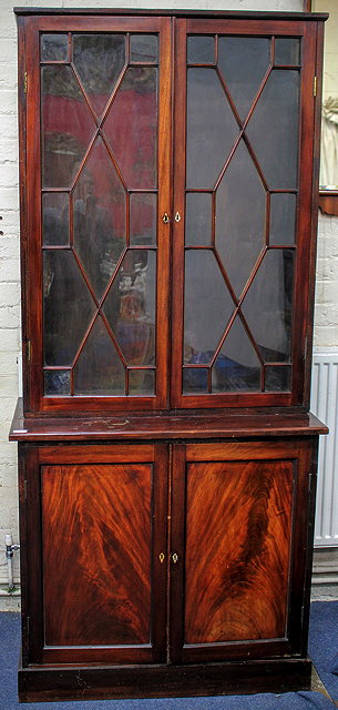 Appraisal: A GEORGIAN STYLE MAHOGANY BOOKCASE CABINET with astragal glazed doors