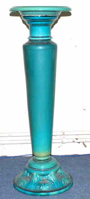 Appraisal: A BRETBY TURQUOISE POTTERY JARDINIERE STAND with embossed foliate decoration