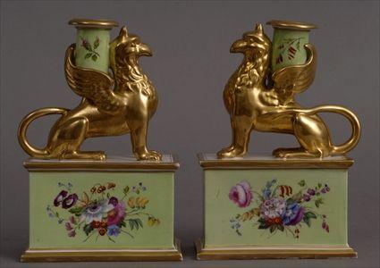 Appraisal: PAIR OF PORCELAIN GRIFFIN-FORM CANDLESTICKS Each gilt winged beast seated