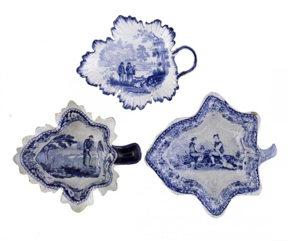 Appraisal: THREE BLUE PRINTED EARTHENWARE PICKLE DISHES of leaf shape Villagers