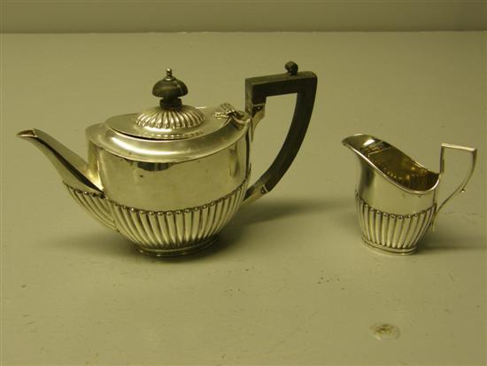 Appraisal: Edward VII silver teapot and helmet shaped cream jug each