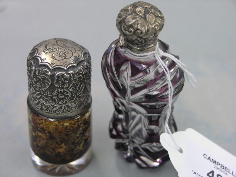 Appraisal: An amethyst overlaid glass scent bottle with embossed silver cover