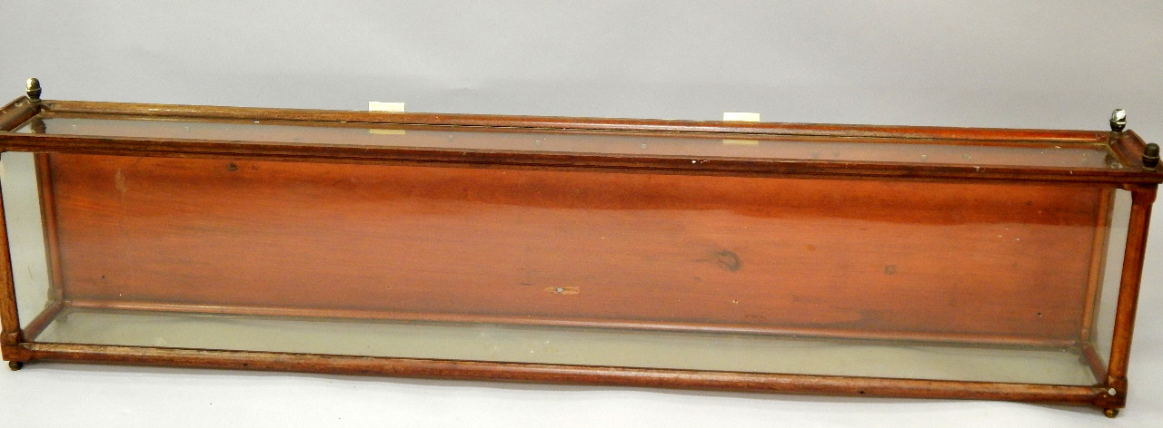 Appraisal: A Victorian mahogany and glazed display case raised on brass