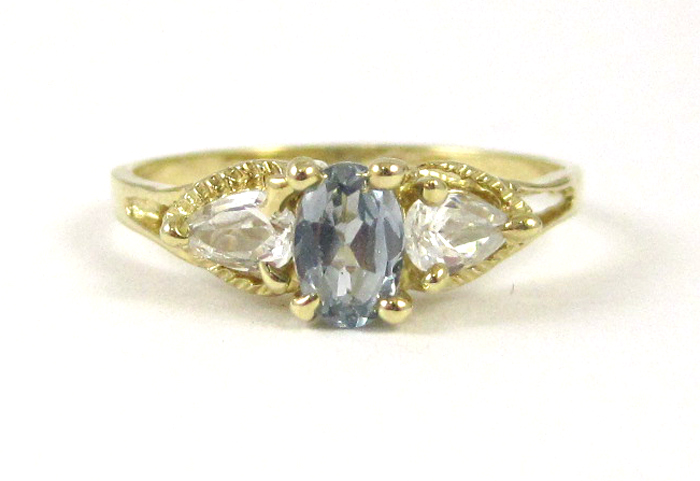 Appraisal: AQUAMARINE AND FOURTEEN KARAT GOLD RING set with two pear-cut