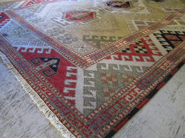 Appraisal: HAND KNOTTED ORIENTAL CARPET Indo-Caucasian three geometric medallion design on