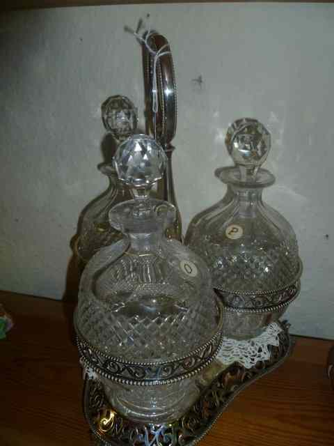 Appraisal: A SILVER PLATED THREE DECANTER CRUET on a silver plated