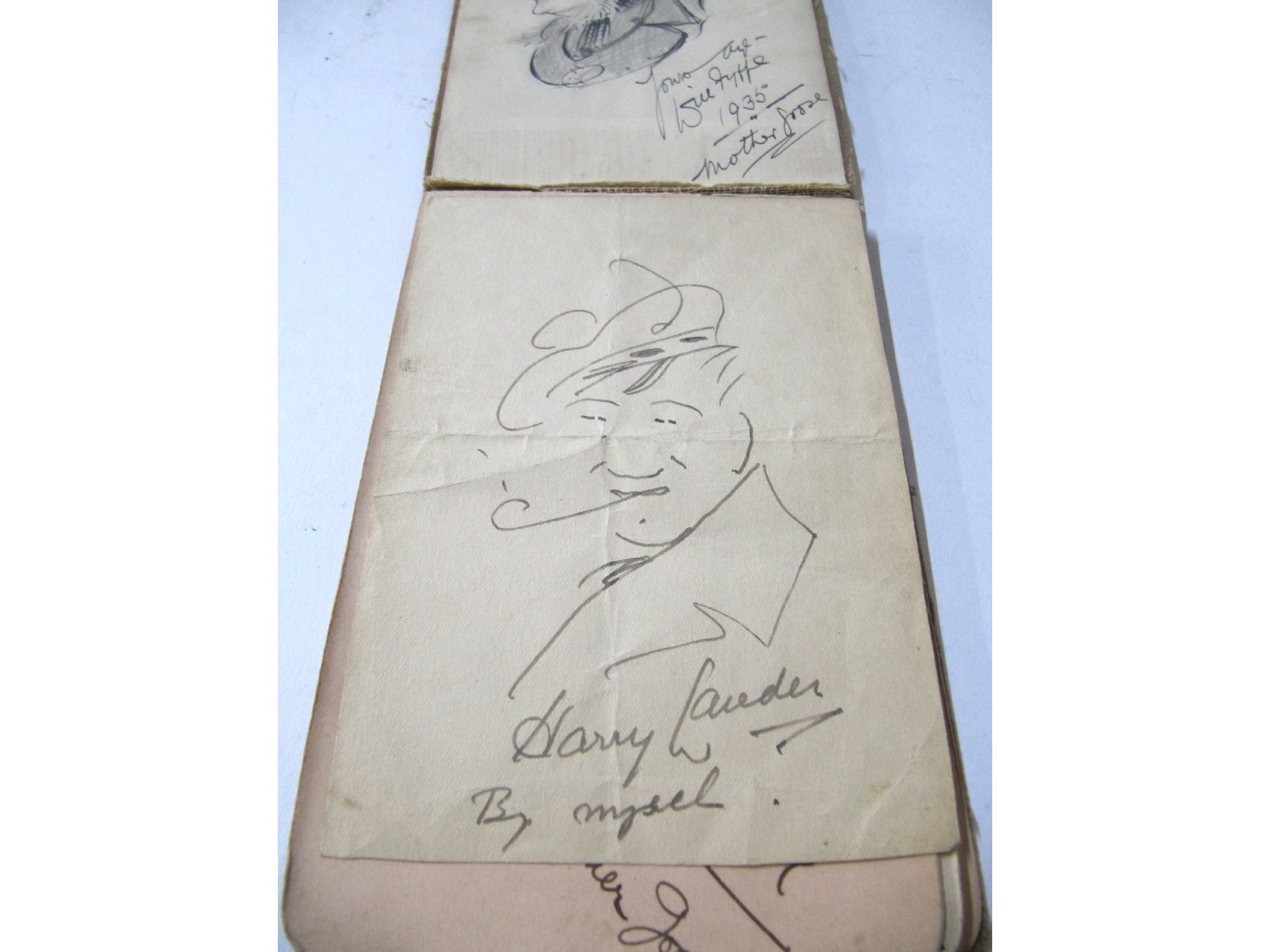 Appraisal: An autograph book with Will Fyffe and Harry Lauder autographs