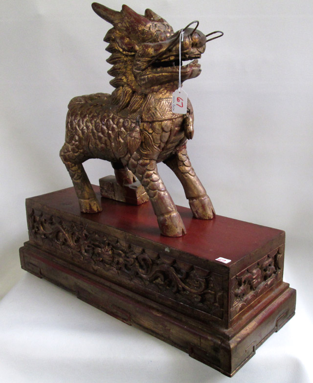 Appraisal: CHINESE WOOD CARVED FOO DOG having gilt finish treatment and