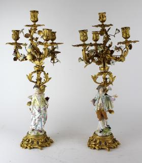 Appraisal: Pair of figural porcelain bronze candleabra with porcelain flowers h