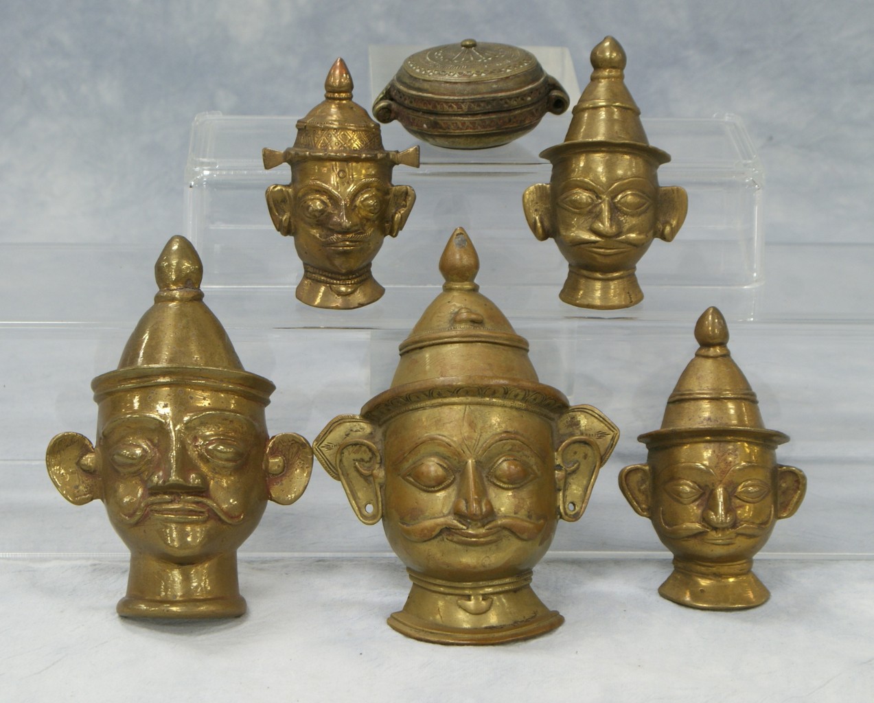 Appraisal: Pieces Indian brass heads and small cosmetic box largest long