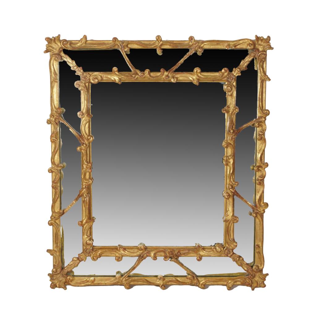 Appraisal: CARVED GILTWOOD WALL MIRROR th century the beveled rectangular plated