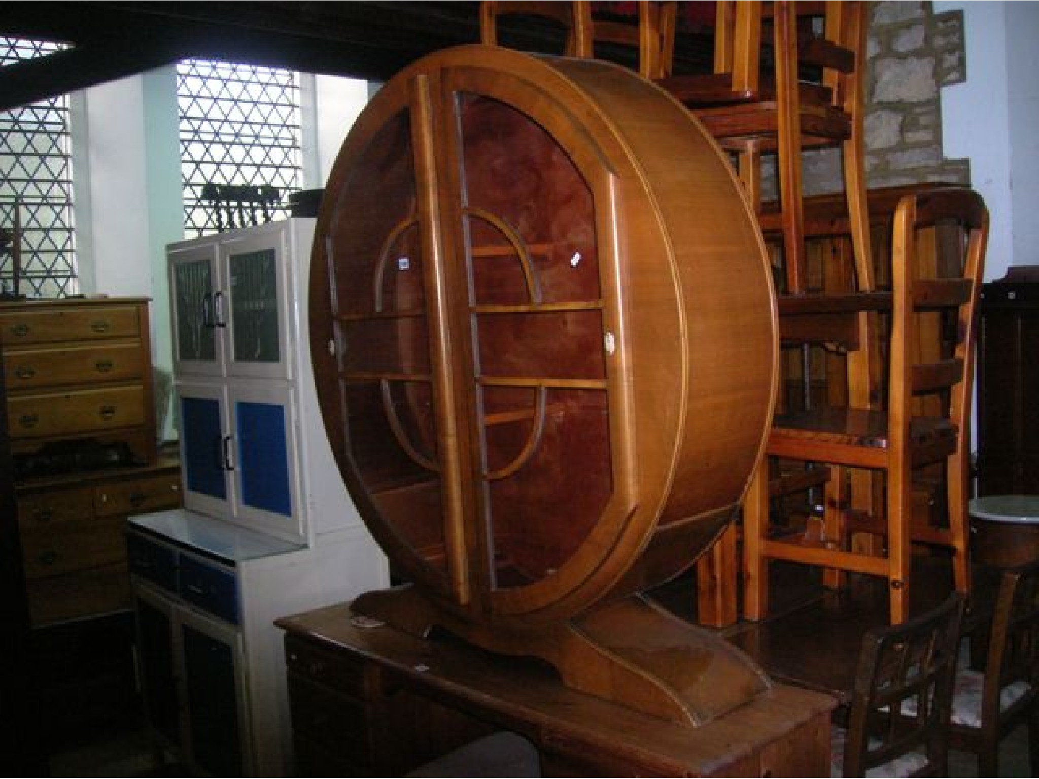 Appraisal: An Art Deco style walnut veneered display cabinet of circular