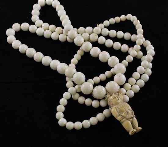 Appraisal: A Chinese ivory toggle and an ivory bead necklace th