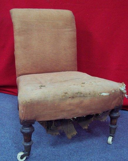 Appraisal: An early Victorian nursing chair the upholstered scroll back and