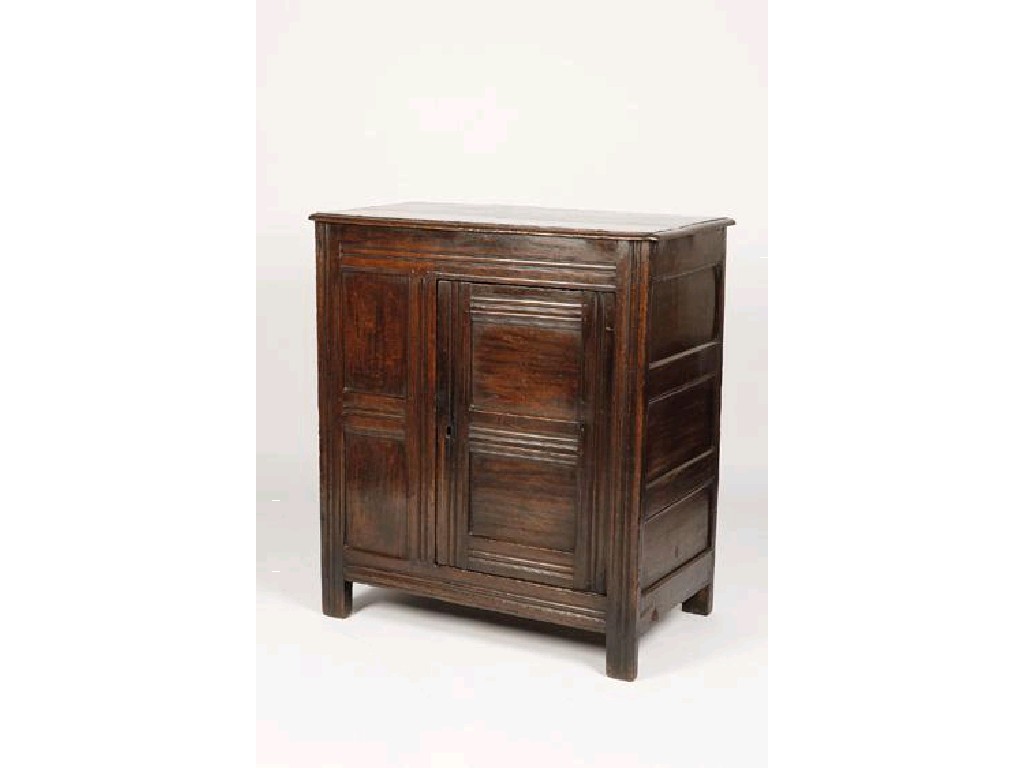 Appraisal: A CHARLES II OAK CUPBOARD the rectangular top with moulded