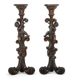 Appraisal: ITALIAN BAROQUE STYLE WALNUT PEDESTALS Each carved with a cherub