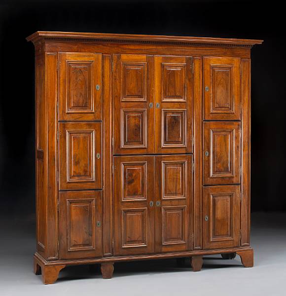 Appraisal: An Italian Baroque style walnut armoire The dentil banded stepped