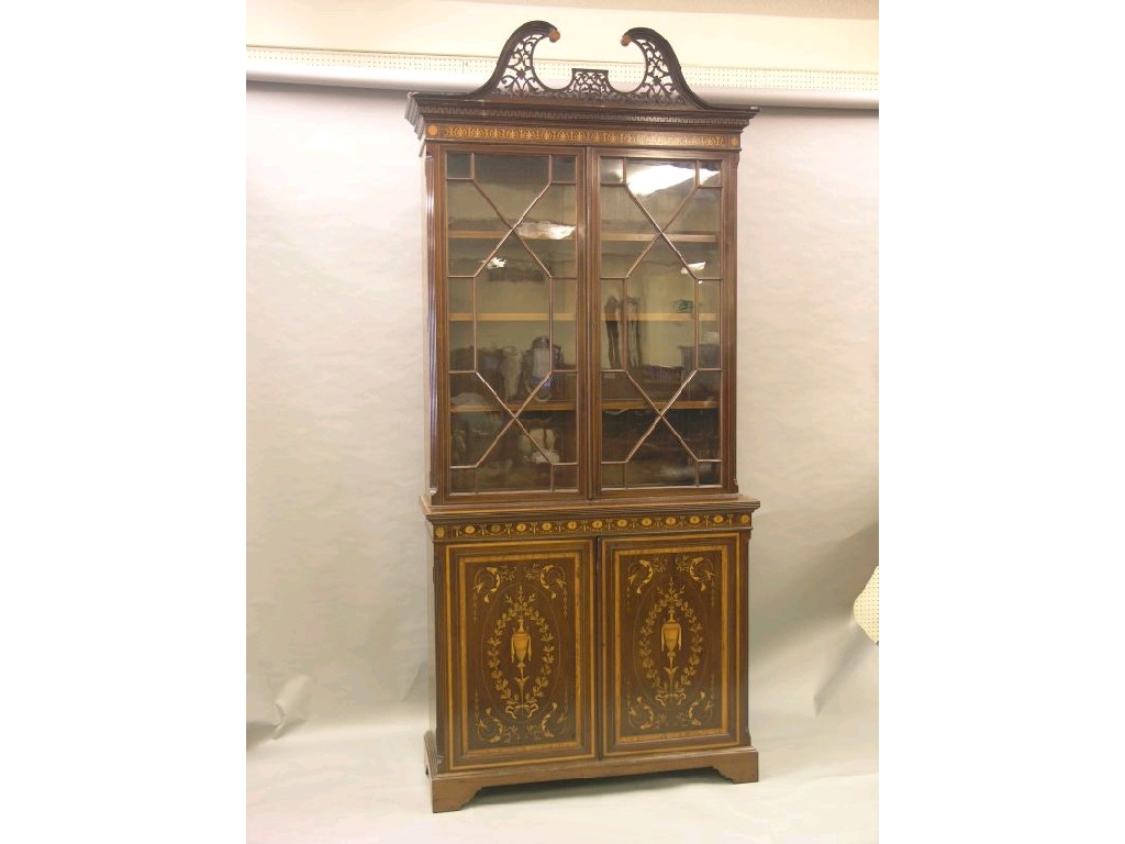 Appraisal: A fine Edwardian inlaid mahogany tall bookcase in the style