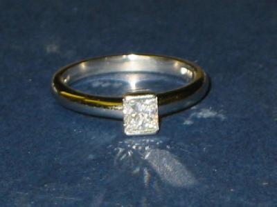 Appraisal: A SOLITAIRE DIAMOND RING the emerald cut stone approximately cts