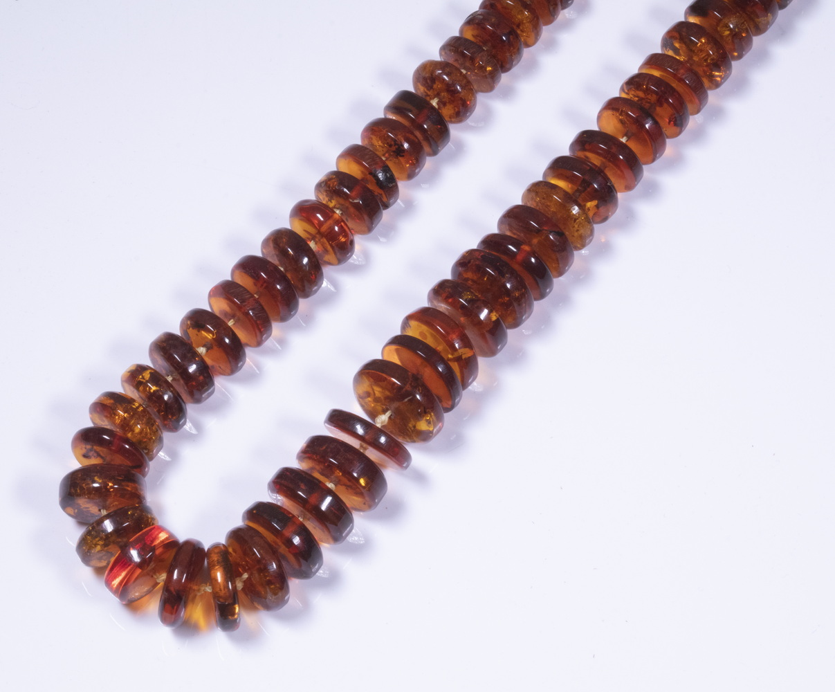 Appraisal: AMBER BEAD NECKLACE Single Strand of Graduated Disk Form Natural