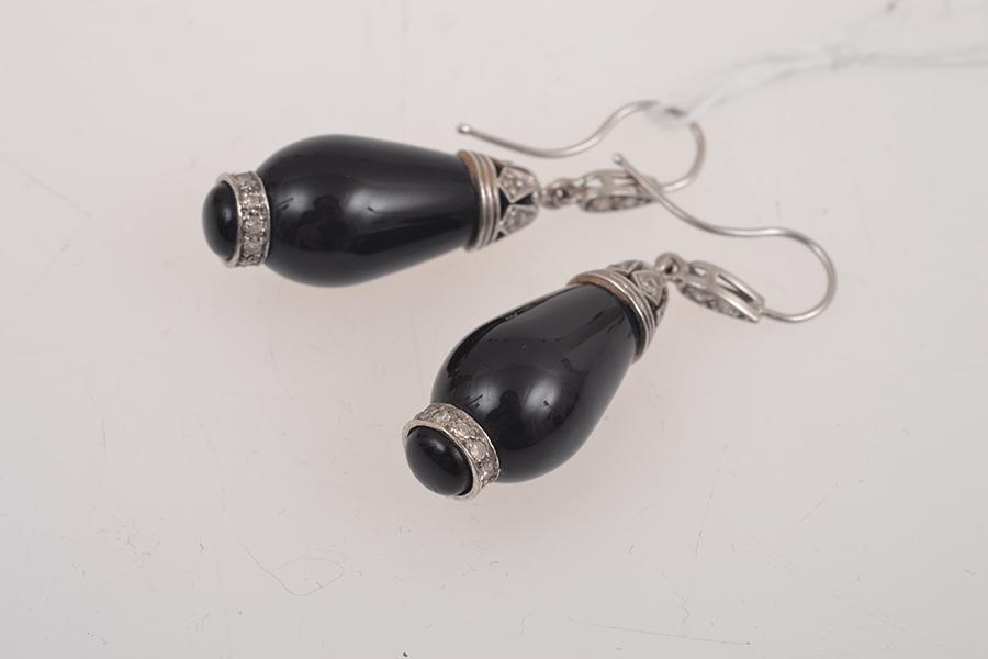 Appraisal: A PAIR OF ONYX AND DIAMOND EARRINGS IN WHITE GOLD