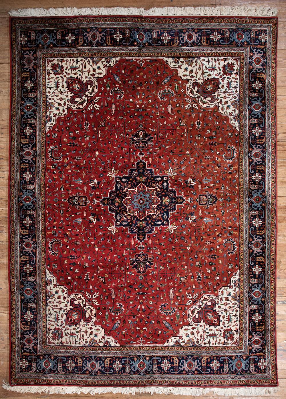 Appraisal: Heriz Carpet red ground blue border white spandrels central medallion