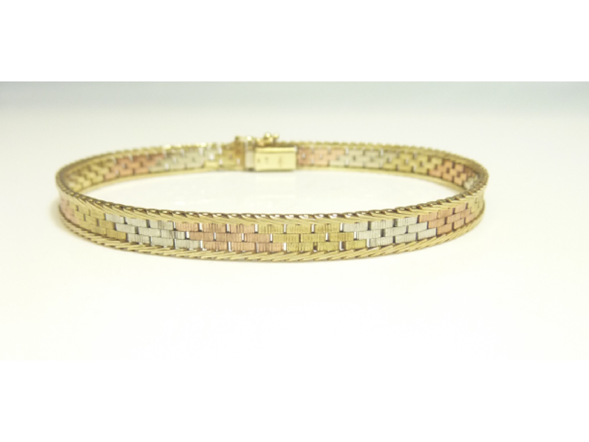 Appraisal: A tri-colour ct gold bracelet composed of textured brick-links length