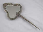 Appraisal: A Dutch silver trefoil shaped hand mirror with ornate frame