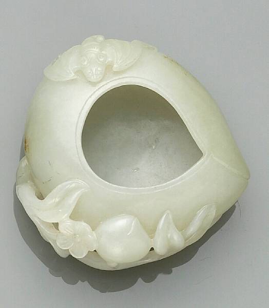 Appraisal: A jade carving of a peach-shaped water coupe Decorated to