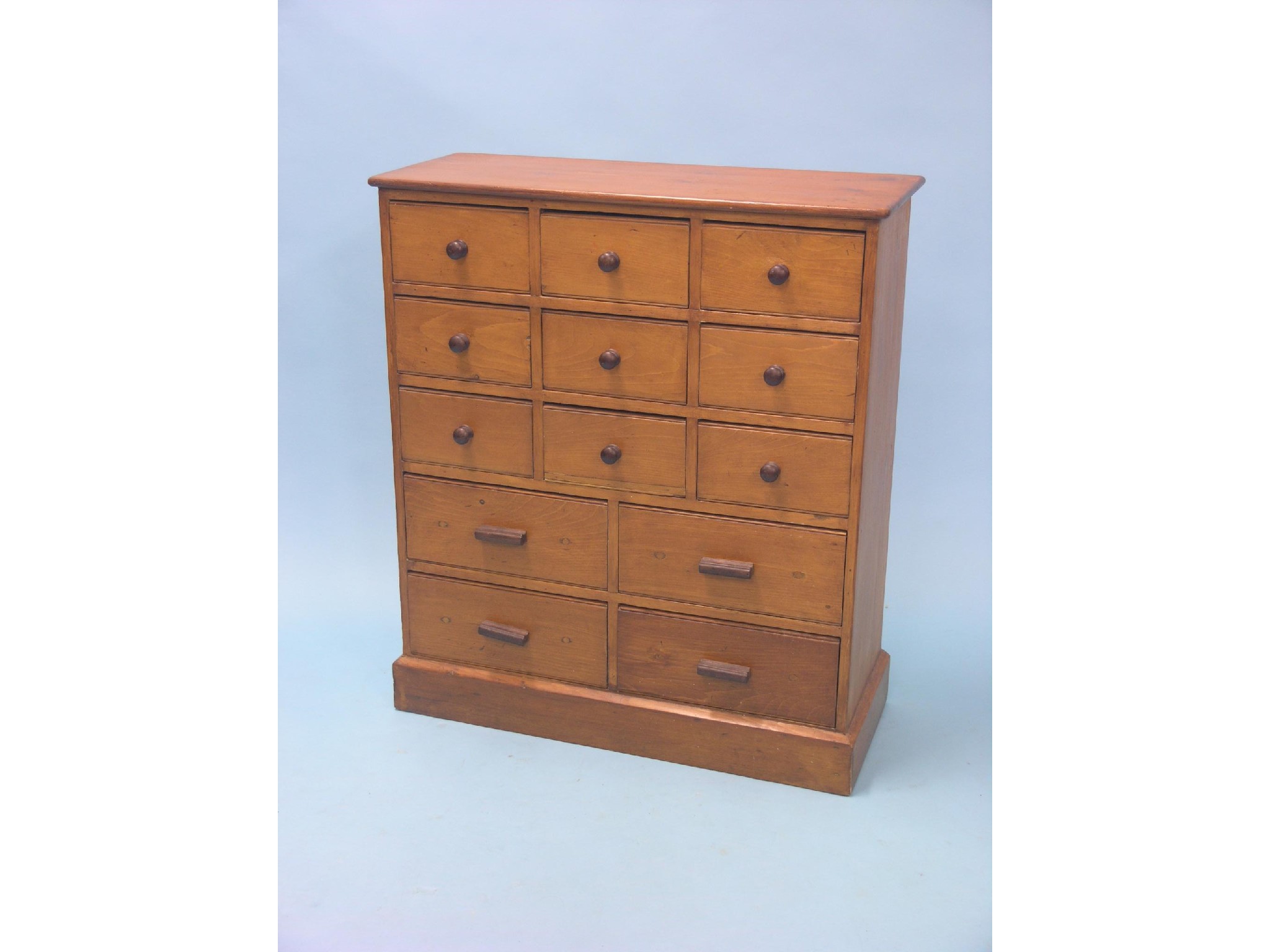 Appraisal: A light-stained pine storage chest nine short and four long