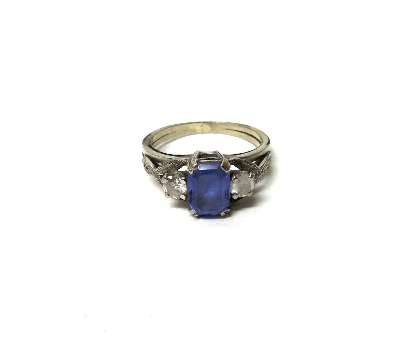 Appraisal: A tanzanite and diamond set three stone ring claw set