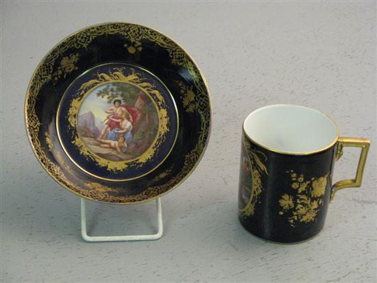 Appraisal: Vienna style Coffee can and saucer deep blue ground cartouche