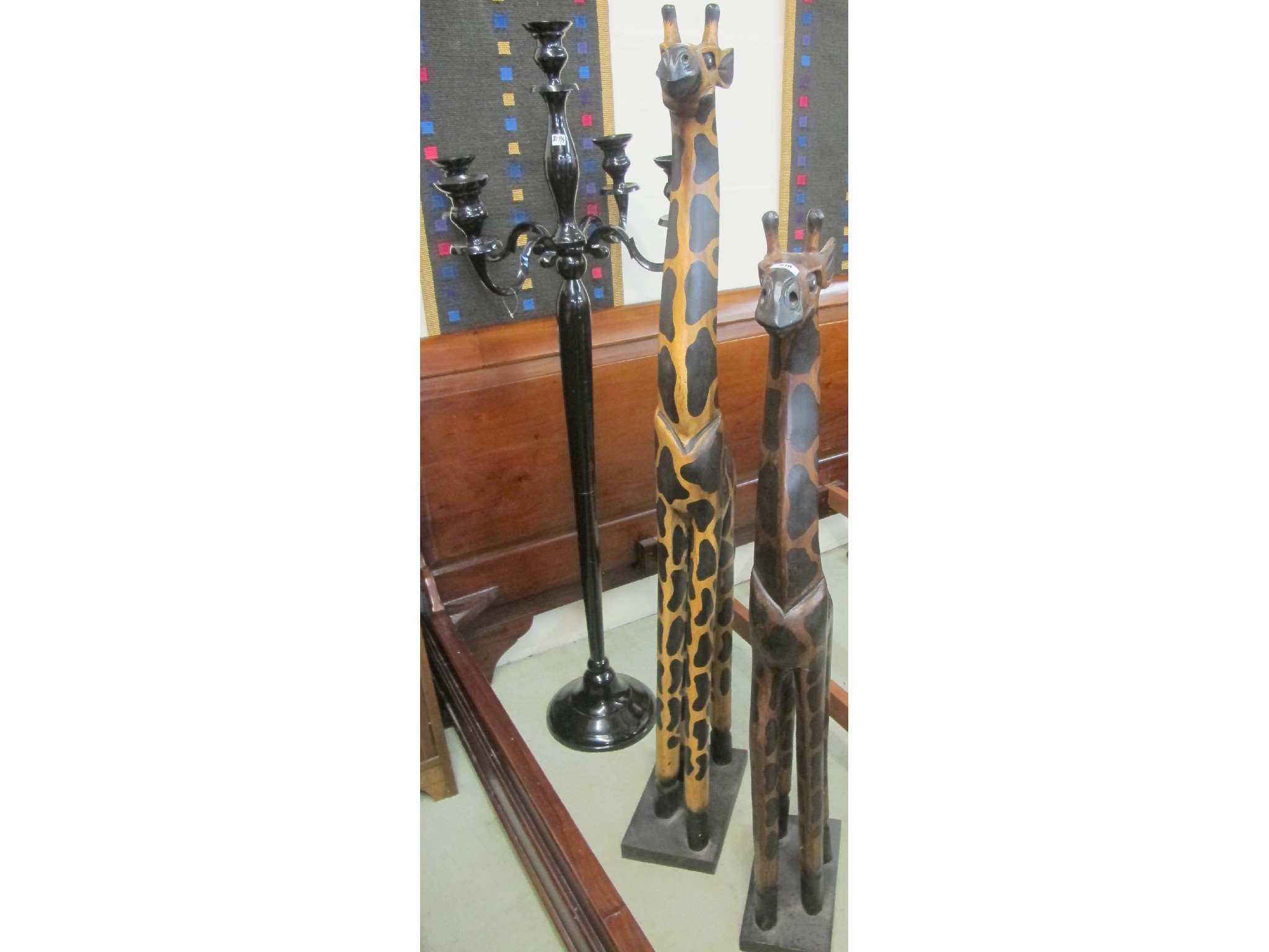 Appraisal: Two carved wooden giraffes and cm tall and a black