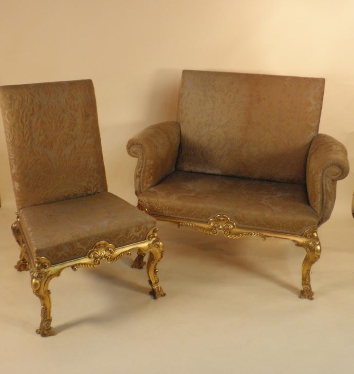 Appraisal: A thC continental giltwood sofa upholstered in green damask carved