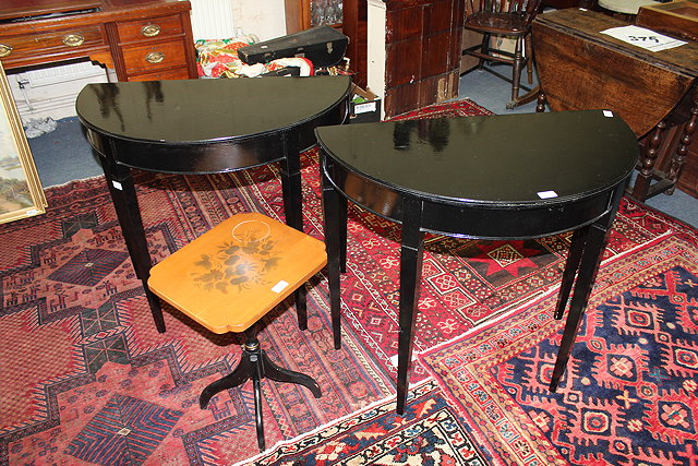 Appraisal: A PAIR OF BLACK PAINTED 'D' SHAPED PIER TABLES standing