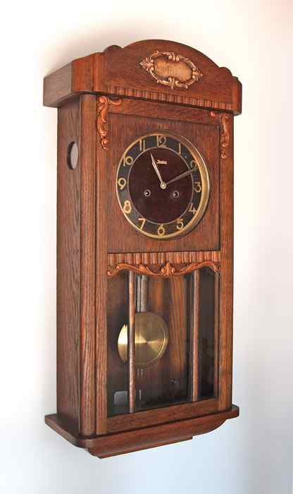 Appraisal: JUNGHANS ART DECO WALL CLOCK Oak case with applied decoration