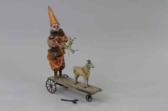 Appraisal: CLOWN AND LAMB ON PLATFORM MECHANICAL TOY Clockwork driven depicts