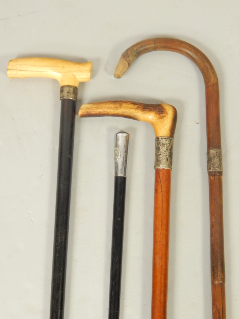 Appraisal: A Victorian ebony walking stick with an ivory handle silver