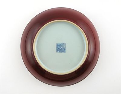 Appraisal: A Chinese sang de boeuf glazed saucer dish the glaze