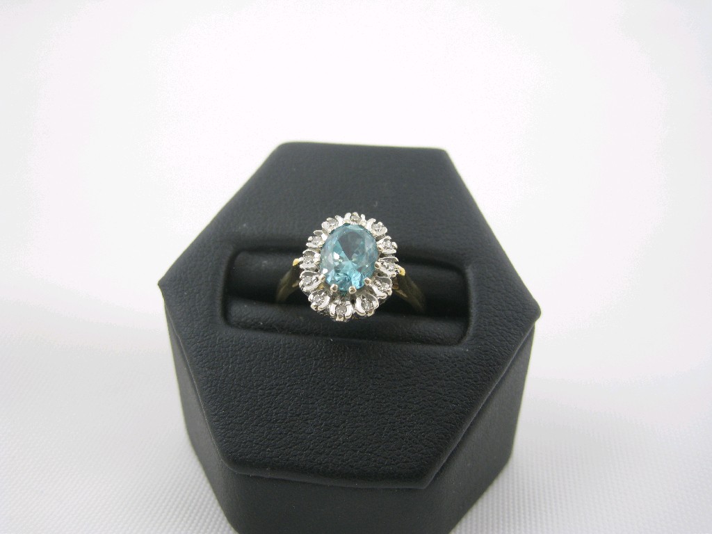 Appraisal: An Aquamarine and Diamond Cluster Ring the central oval-cut aquamarine