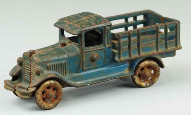 Appraisal: A C WILLIAMS STAKE TRUCK Cast iron enclosed Ford cab