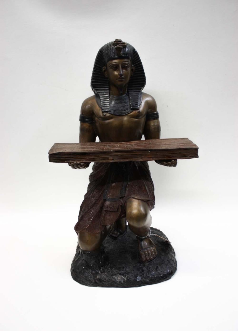 Appraisal: BRONZE STATUE OF AN EGYPTIAN MAN holding a papyrus book