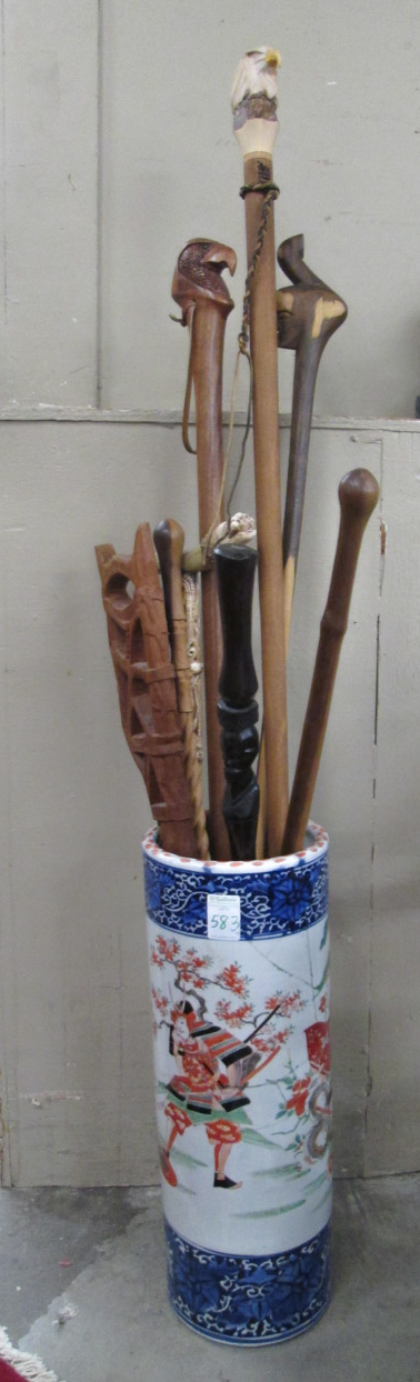 Appraisal: FIVE CANES AND THREE WALKING STICKS IN PORCELAIN UMBRELLA STAND