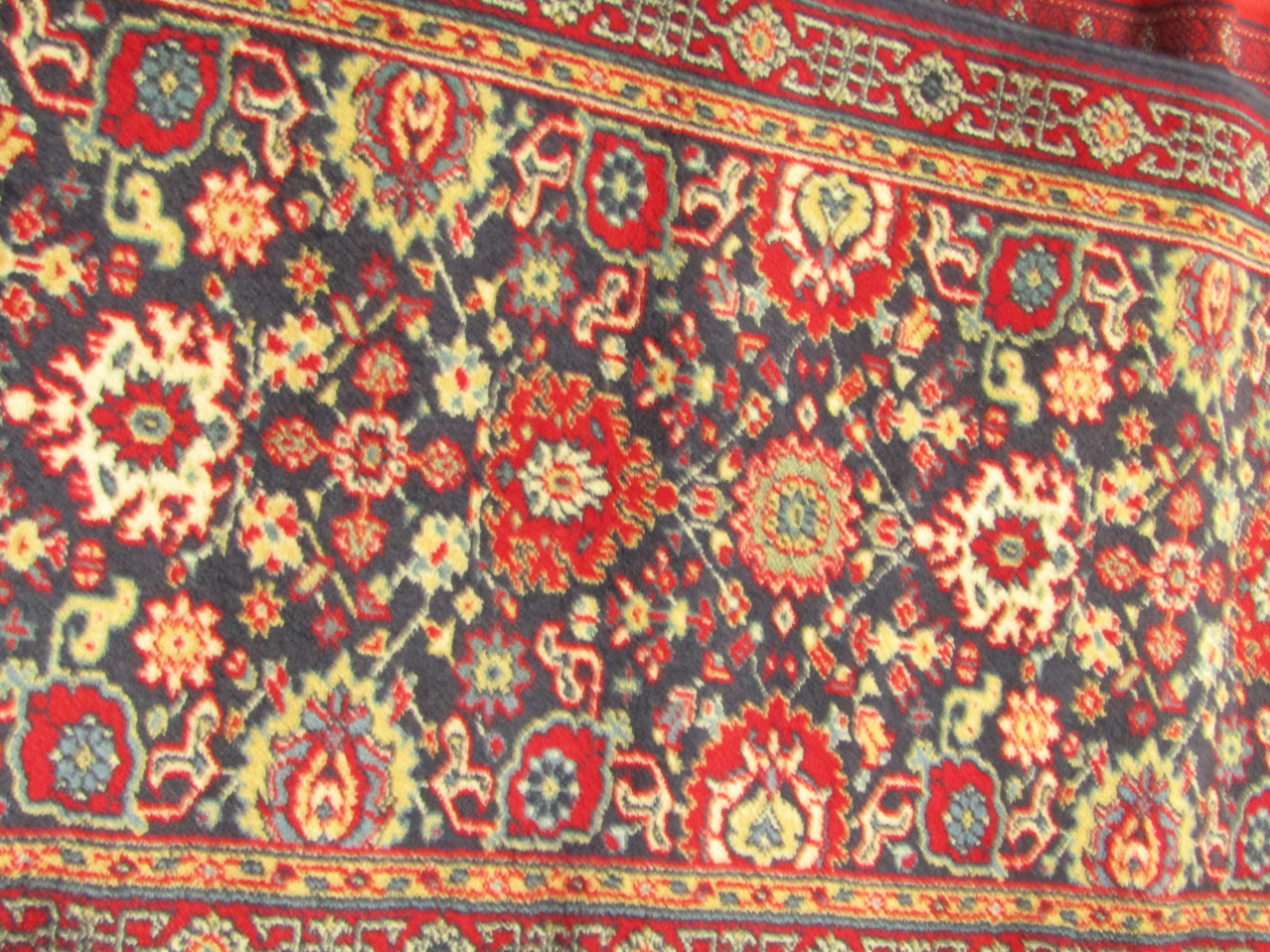 Appraisal: A Basra rug decorated with floral motifs against a blue