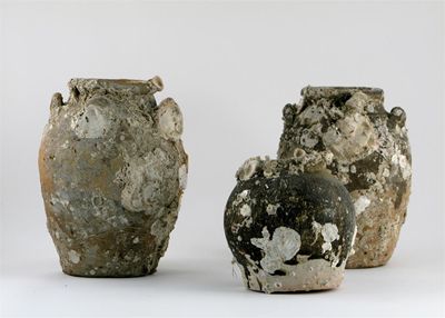 Appraisal: Three South-East Asian ovoid pottery vases encrusted with marine life