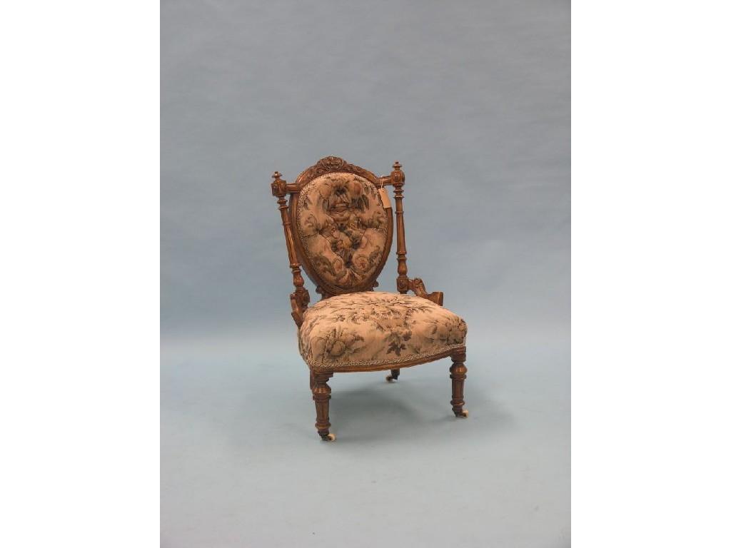 Appraisal: A Victorian walnut-framed nursing chair frame with carved leaf-scroll cresting